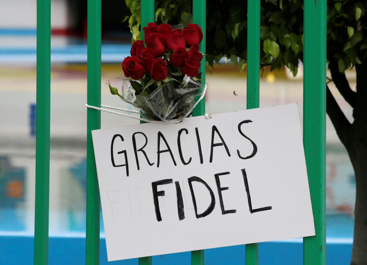 A placard and flowers are seen outside the Cuban Embassy as a tribute following the announcement of the death of Cuban revolutionary leader Fidel Castro, in Mexico City, Mexico, November 26, 2016. The placard reads: "Thanks, Fidel". REUTERS/Henry Romero